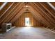 Unfinished attic space with natural light, exposed beams and trusses offer potential for customization at 100 N Ridge View Way, Franklinton, NC 27525