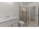 Contemporary bathroom featuring a glass enclosed shower, white vanity, and marbled tile floors at 100 N Ridge View Way, Franklinton, NC 27525