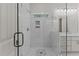 Modern bathroom featuring glass enclosed shower, marble tile, and double vanity at 100 N Ridge View Way, Franklinton, NC 27525