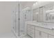 Modern bathroom featuring glass enclosed shower, marble tile, and double vanity at 100 N Ridge View Way, Franklinton, NC 27525