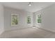 Bright bedroom with three windows and neutral carpet, offering ample natural light and a calming atmosphere at 100 N Ridge View Way, Franklinton, NC 27525