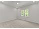 A bright, carpeted bedroom featuring a single window, complemented by recessed lighting at 100 N Ridge View Way, Franklinton, NC 27525