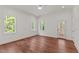 This spacious bedroom features hardwood floors, natural light, a ceiling fan and an exterior door to the back porch at 100 N Ridge View Way, Franklinton, NC 27525