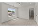 Bright bedroom with a window, featuring neutral carpet and an open door frame to the bathroom at 100 N Ridge View Way, Franklinton, NC 27525