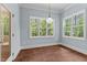Light-filled dining room features hardwood floors, neutral paint, trim detail, and windows overlooking the lush yard at 100 N Ridge View Way, Franklinton, NC 27525