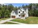 Beautiful new construction features board and batten siding, a charming entryway, and a manicured front lawn at 100 N Ridge View Way, Franklinton, NC 27525