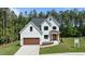 Stunning new construction with a board and batten siding, a welcoming entryway, and a three car garage at 100 N Ridge View Way, Franklinton, NC 27525