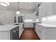 Bright kitchen features white cabinets, stainless steel appliances, hardwood floors, and a large center island at 100 N Ridge View Way, Franklinton, NC 27525