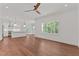 Open-concept living space with hardwood floors, bright lighting, and kitchen island at 100 N Ridge View Way, Franklinton, NC 27525