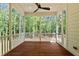 Inviting screened-in porch with wood floors and tranquil wooded backdrop at 100 N Ridge View Way, Franklinton, NC 27525
