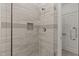Contemporary glass shower stall featuring marbled tile surround and shower niche at 100 N Ridge View Way, Franklinton, NC 27525