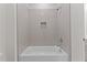 Clean, well lit, white-tiled tub/shower combo with shower niche and chrome fixtures at 100 N Ridge View Way, Franklinton, NC 27525