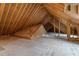 Spacious unfinished attic area ready to be converted to livable space with exposed rafters and plywood subfloor at 225 Whistlers Cv, Louisburg, NC 27549