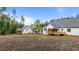 Large backyard featuring a wooden deck and screened-in porch with lush trees in the background at 225 Whistlers Cv, Louisburg, NC 27549