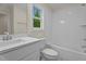 Bathroom with a white single vanity, tub, shower combo, and patterned tile flooring at 225 Whistlers Cv, Louisburg, NC 27549