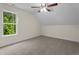 Bedroom featuring carpet, natural light from a window with view of outdoors and modern ceiling fan at 225 Whistlers Cv, Louisburg, NC 27549