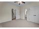Neutral bedroom featuring carpeted floors, closet, and ceiling fan with easy access to stairs and bathroom at 225 Whistlers Cv, Louisburg, NC 27549