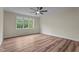Bright bedroom with a large window, ceiling fan, and hardwood floors at 225 Whistlers Cv, Louisburg, NC 27549