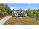A beautiful, sprawling single-Gathering home surrounded by mature trees and a long driveway at 225 Whistlers Cv, Louisburg, NC 27549