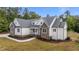 Beautiful exterior shot of the home showcasing stone accents, white siding, and well-maintained landscaping at 225 Whistlers Cv, Louisburg, NC 27549