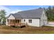 Exterior view of house showing the deck and screened-in porch with the backdrop of a grey roof at 225 Whistlers Cv, Louisburg, NC 27549