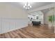 Open-concept kitchen featuring white cabinets, a black island, and stainless steel appliances at 225 Whistlers Cv, Louisburg, NC 27549