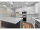 Modern kitchen with white cabinets, stainless steel appliances, and a spacious dark island at 225 Whistlers Cv, Louisburg, NC 27549