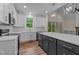 Bright, modern kitchen featuring white cabinets, a dark island, and stainless steel appliances at 225 Whistlers Cv, Louisburg, NC 27549