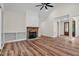 Large living room with stone fireplace, hardwood floors, and a traditional glass paneled front door at 225 Whistlers Cv, Louisburg, NC 27549