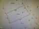 Plot map displaying property lines with key dimensions and property numbers, giving insight to land layout at 225 Whistlers Cv, Louisburg, NC 27549