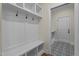 Well-organized mudroom with built-in bench and storage, leading to an exterior door at 225 Whistlers Cv, Louisburg, NC 27549
