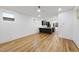 Spacious living room features modern ceiling fan and hardwood floors that transition into a large kitchen at 2708 A Ashley St, Durham, NC 27704