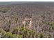 High aerial shot of a property build nestled among trees, showcasing serene setting at 2817 Silk Hope Gum Springs Rd, Pittsboro, NC 27312