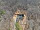 A high aerial view of a home build surrounded by a lush forest at 2817 Silk Hope Gum Springs Rd, Pittsboro, NC 27312