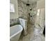 Bathroom featuring a marble walk-in shower with rainfall shower head and soaker tub at 2817 Silk Hope Gum Springs Rd, Pittsboro, NC 27312