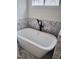 Modern bathroom showcasing a sleek freestanding tub with stylish black fixtures against marble tile backdrop at 2817 Silk Hope Gum Springs Rd, Pittsboro, NC 27312