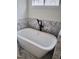 A freestanding bathtub features elegant fixtures and marble tiling at 2817 Silk Hope Gum Springs Rd, Pittsboro, NC 27312
