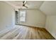 Bedroom with hardwood floors, ceiling fan, recessed lighting, and a large window at 2817 Silk Hope Gum Springs Rd, Pittsboro, NC 27312
