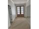 Elegant entryway featuring herringbone wood floors and a view of the beautiful double doors at 2817 Silk Hope Gum Springs Rd, Pittsboro, NC 27312