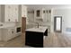 Modern kitchen featuring white cabinets, a large island, and stainless steel appliances at 2817 Silk Hope Gum Springs Rd, Pittsboro, NC 27312