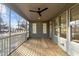 Relaxing screened-in back porch featuring modern ceiling fan and a view of the private wooded backyard at 5300 Pulley Town Rd, Zebulon, NC 27597