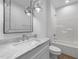 A well-lit bathroom features a marble vanity, a large mirror, and a shower-tub combo at 5300 Pulley Town Rd, Zebulon, NC 27597