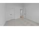 Bright bedroom with neutral carpet, white walls, trim, and paneled doors showcasing modern, minimalist design at 5300 Pulley Town Rd, Zebulon, NC 27597