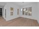 Bright dining room with modern lighting, large windows, and open flow to the kitchen at 5300 Pulley Town Rd, Zebulon, NC 27597