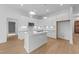 Modern kitchen boasts white cabinets, stainless steel appliances, and quartz countertops on island at 5300 Pulley Town Rd, Zebulon, NC 27597