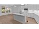 Bright, modern kitchen with quartz counters, stainless appliances, and an island sink overlooking the living space at 5300 Pulley Town Rd, Zebulon, NC 27597