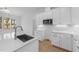 Contemporary kitchen island with stainless steel sink, quartz countertop, and white subway tile backsplash at 5300 Pulley Town Rd, Zebulon, NC 27597