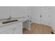 Convenient laundry room with sink, quartz countertops, and storage at 5300 Pulley Town Rd, Zebulon, NC 27597