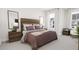 Cozy bedroom with wood headboard and soft bedding at 932 Myers Point Dr # 34, Morrisville, NC 27560