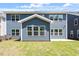 Back of house with blue siding, many windows, and a small yard at 119 Augusta Pond Way # 147, Raleigh, NC 27603